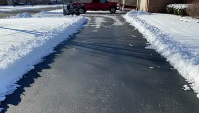 Cleared driveway after professional snow removal by Chop Chop Landscaping in Omaha, NE